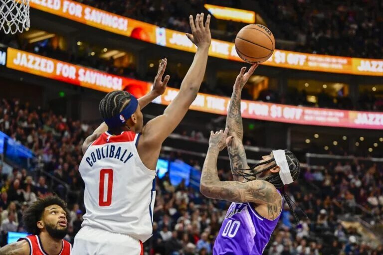 Mar 4, 2024; Salt Lake City, Utah, USA; Utah Jazz guard Jordan Clarkson (00) takes a shot over Washington Wizards guard Bilal Coulibaly (0) during the second half at the Delta Center. Mandatory Credit: Christopher Creveling-USA TODAY Sports