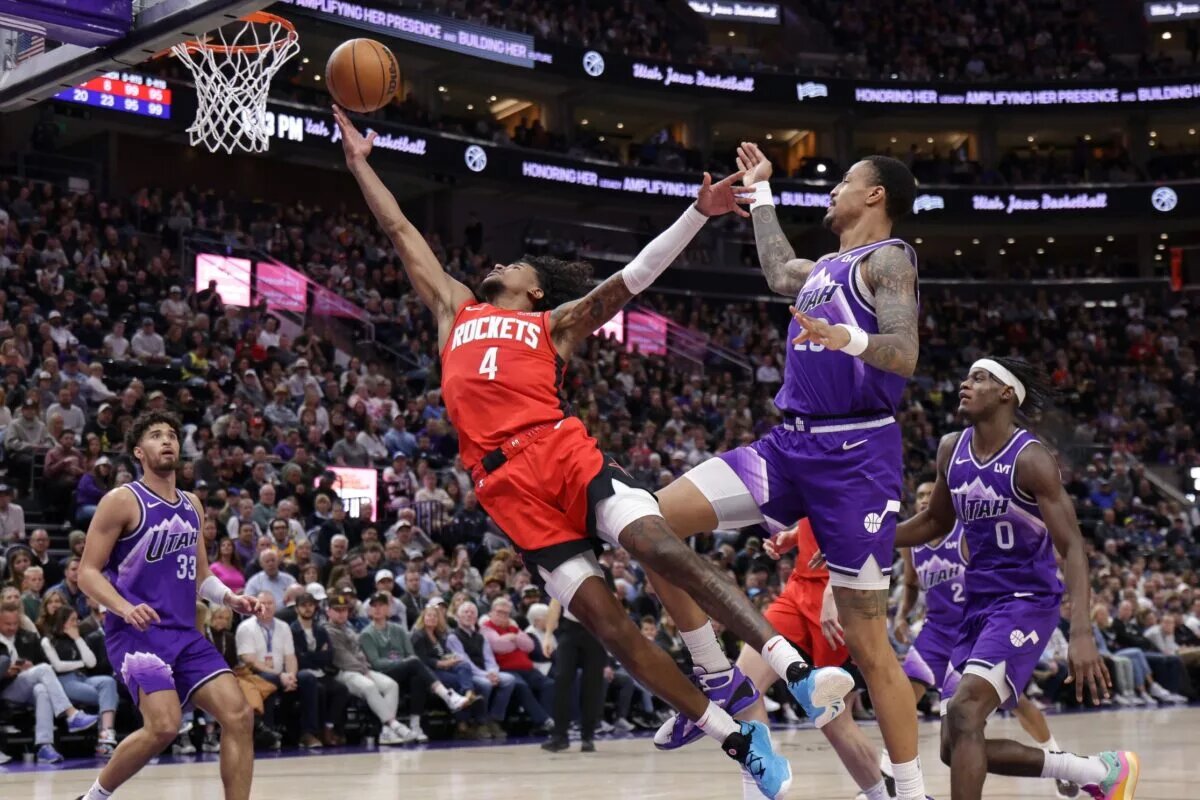 Mar 29, 2024; Salt Lake City, Utah, USA; Houston Rockets guard Jalen Green (4) stretches past Utah Jazz forward John Collins (20) and shoots the ball during the second half at Delta Center. Mandatory Credit: Chris Nicoll-USA TODAY Sports