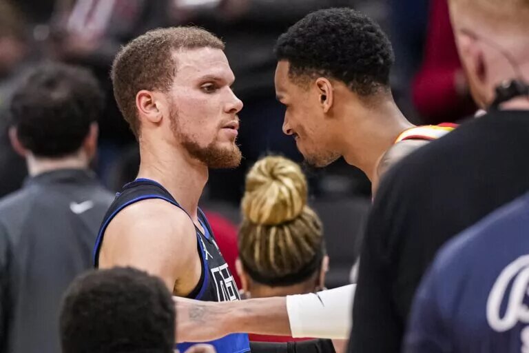 Detroit Pistons guard Malachi Flynn shakes hand of Atlanta Hawks guard Dejounte Murray after career night