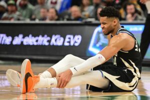 Milwaukee Bucks forward Giannis Antetokounmpo (34) grabs his leg in the third quarter and left game against the Boston Celtics with an injury at Fiserv Forum.