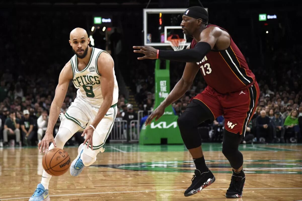 Apr 21, 2024; Boston, Massachusetts, USA; Boston Celtics guard Derrick White (9) controls the ball while Miami Heat center Bam Adebayo (13) defends during the second half in game one of the first round for the 2024 NBA playoffs at TD Garden. Mandatory Credit: Bob DeChiara-USA TODAY Sports