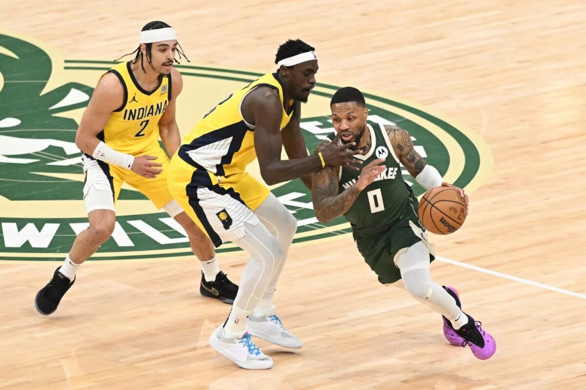 Milwaukee Bucks guard Damian Lillard (0) dribbles past Indiana Pacers forward Pascal Siakam (43) in the first half during game two of the first round for the 2024 NBA playoffs at Fiserv Forum.