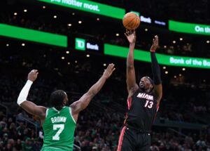Apr 24, 2024; Boston, Massachusetts, USA; Miami Heat center Bam Adebayo (13) shoots against Boston Celtics guard Jaylen Brown (7) in the first quarter during game two of the first round for the 2024 NBA playoffs at TD Garden. Mandatory Credit: David Butler II-USA TODAY Sports
