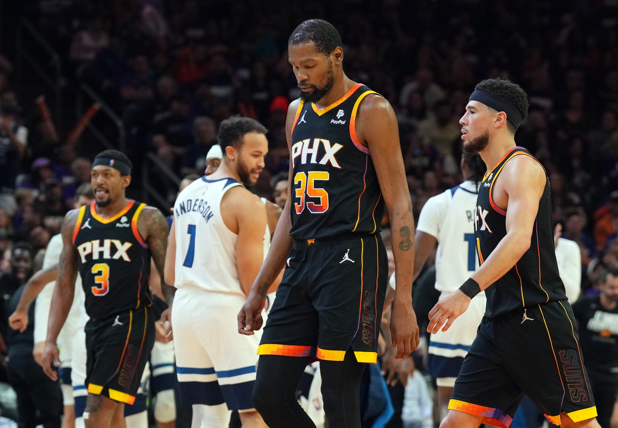 Apr 26, 2024; Phoenix, Arizona, USA; Phoenix Suns guard Bradley Beal (3) and Phoenix Suns forward Kevin Durant (35) and Phoenix Suns guard Devin Booker (1) react while Minnesota Timberwolves celebrate during the second half of game three of the first round for the 2024 NBA playoffs at Footprint Center. Mandatory Credit: Joe Camporeale-USA TODAY Sports