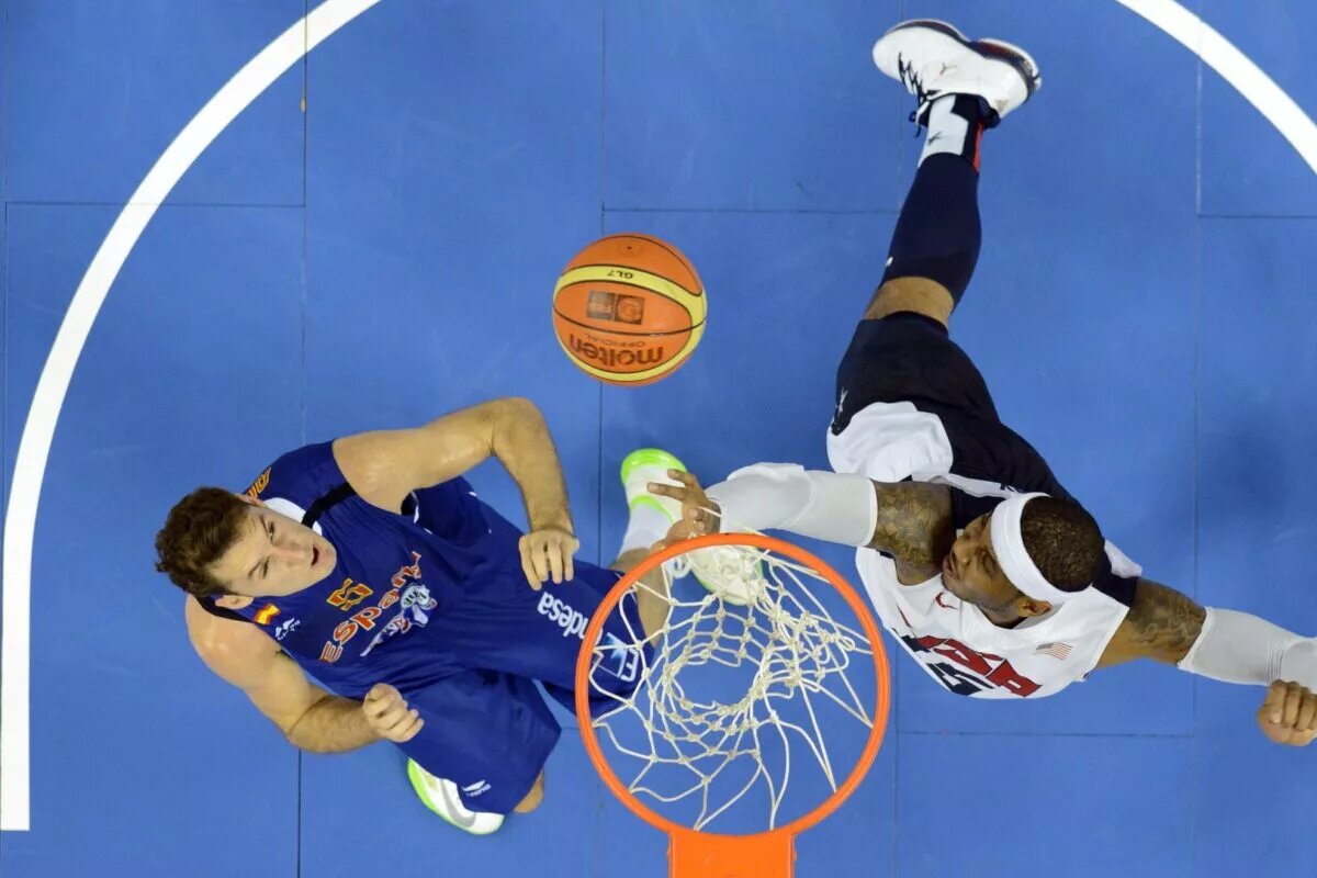 July 24, 2012; Barcelona, SPAIN; USA forward Carmelo Anthony (15) battles for a rebound with Spain forward Rudy Fernandez (5) during an exhibition game in preparation for the 2012 London Olympic Games at Palau Sant Jordi. Mandatory Credit: Bob Donnan-USA TODAY Sports
