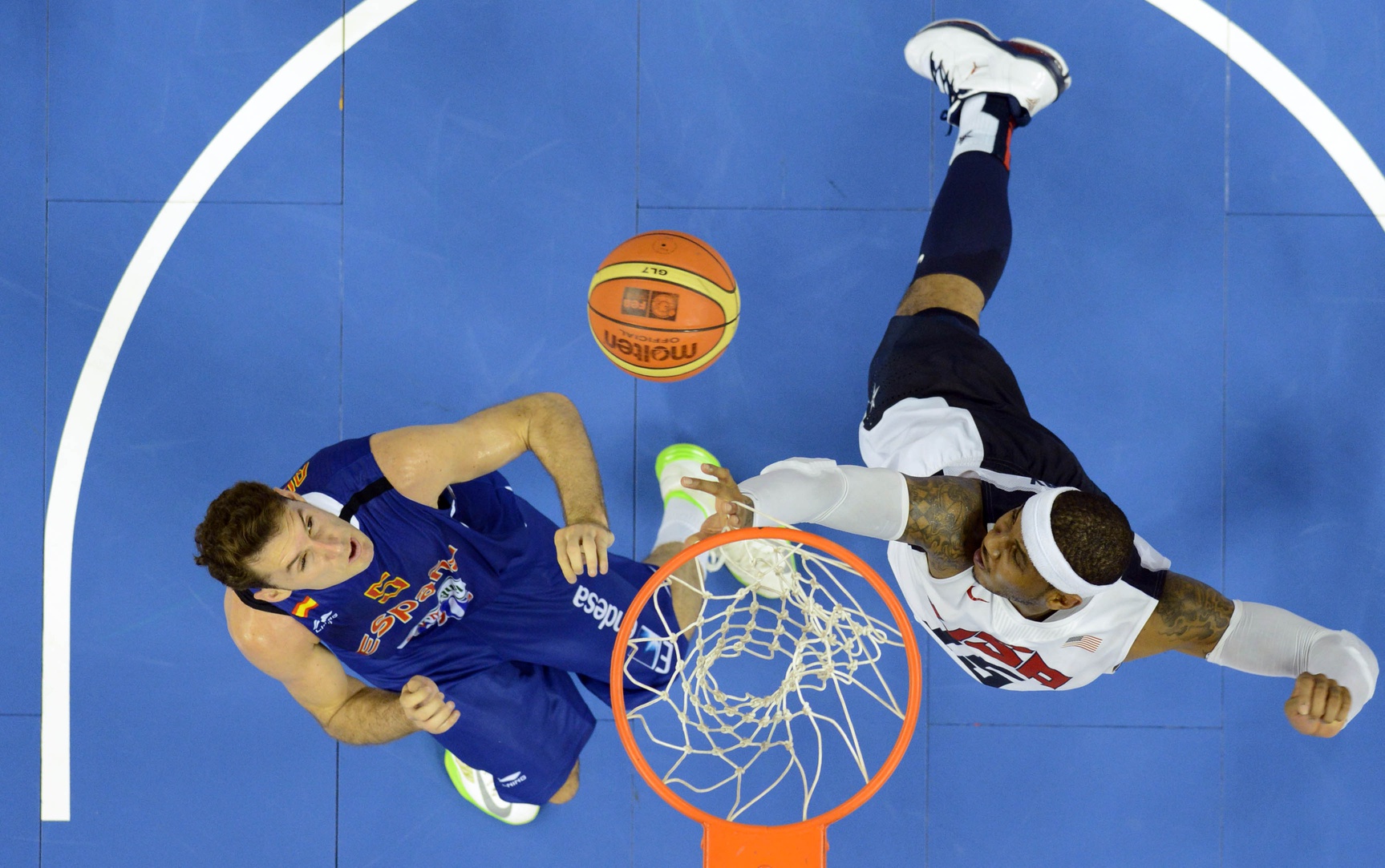 July 24, 2012; Barcelona, SPAIN; USA forward Carmelo Anthony (15) battles for a rebound with Spain forward Rudy Fernandez (5) during an exhibition game in preparation for the 2012 London Olympic Games at Palau Sant Jordi. Mandatory Credit: Bob Donnan-USA TODAY Sports