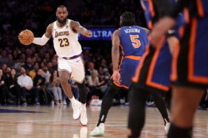 Los Angeles Lakers forward LeBron James points at New York Knicks defenders