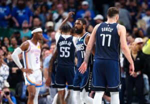 Dallas Mavericks guards Luka Doncic and Kyrie Irving in front of Oklahoma City Thunder guard Shai Gilgeous-Alexander