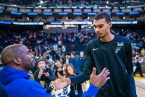 Los Angeles Lakers trade target, Golden State Warriors guard Chris Paul greets San Antonio Spurs center Victor Wembanyama