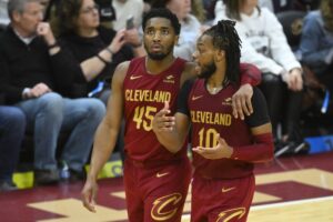 Cleveland Cavaliers guards Donovan Mitchell and Darius Garland walk down the court talking