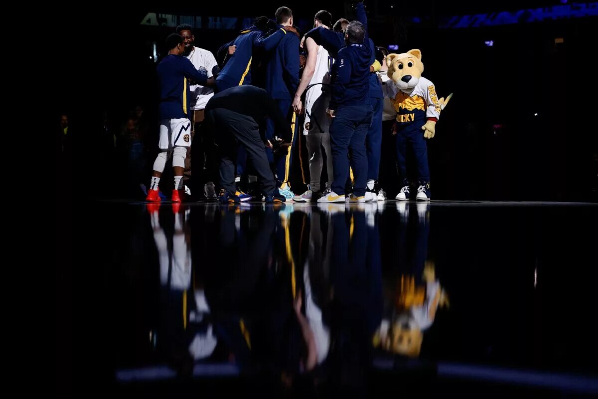 Denver Nuggets players huddle before the game against the Sacramento Kings at Ball Arena