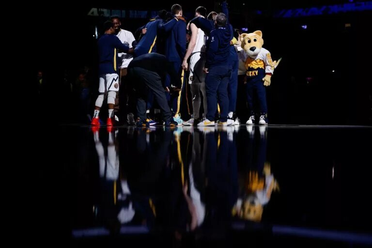 Denver Nuggets players huddle before the game against the Sacramento Kings at Ball Arena