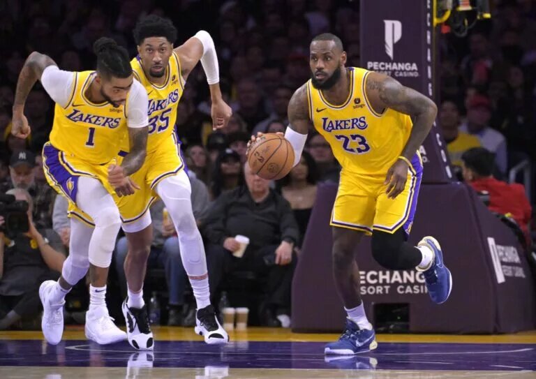 Dec 28, 2023; Los Angeles, California, USA; Los Angeles Lakers guard D'Angelo Russell (1) and forward Christian Wood (35) trail as forward LeBron James (23) takes the ball down court in the first half against the Charlotte Hornets at Crypto.com Arena. Mandatory Credit: Jayne Kamin-Oncea-USA TODAY Sports