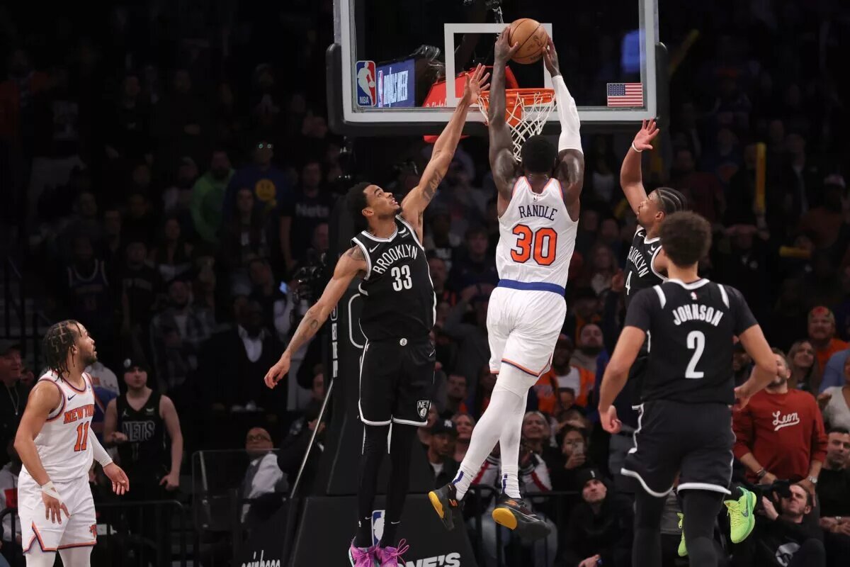 Jan 23, 2024; Brooklyn, New York, USA; New York Knicks forward Julius Randle (30) dunks against Brooklyn Nets center Nic Claxton (33) and guard Dennis Smith Jr. (4) and forward Cameron Johnson (2) in front of Knicks guard Jalen Brunson (11) during the fourth quarter at Barclays Center. Mandatory Credit: Brad Penner-USA TODAY Sports