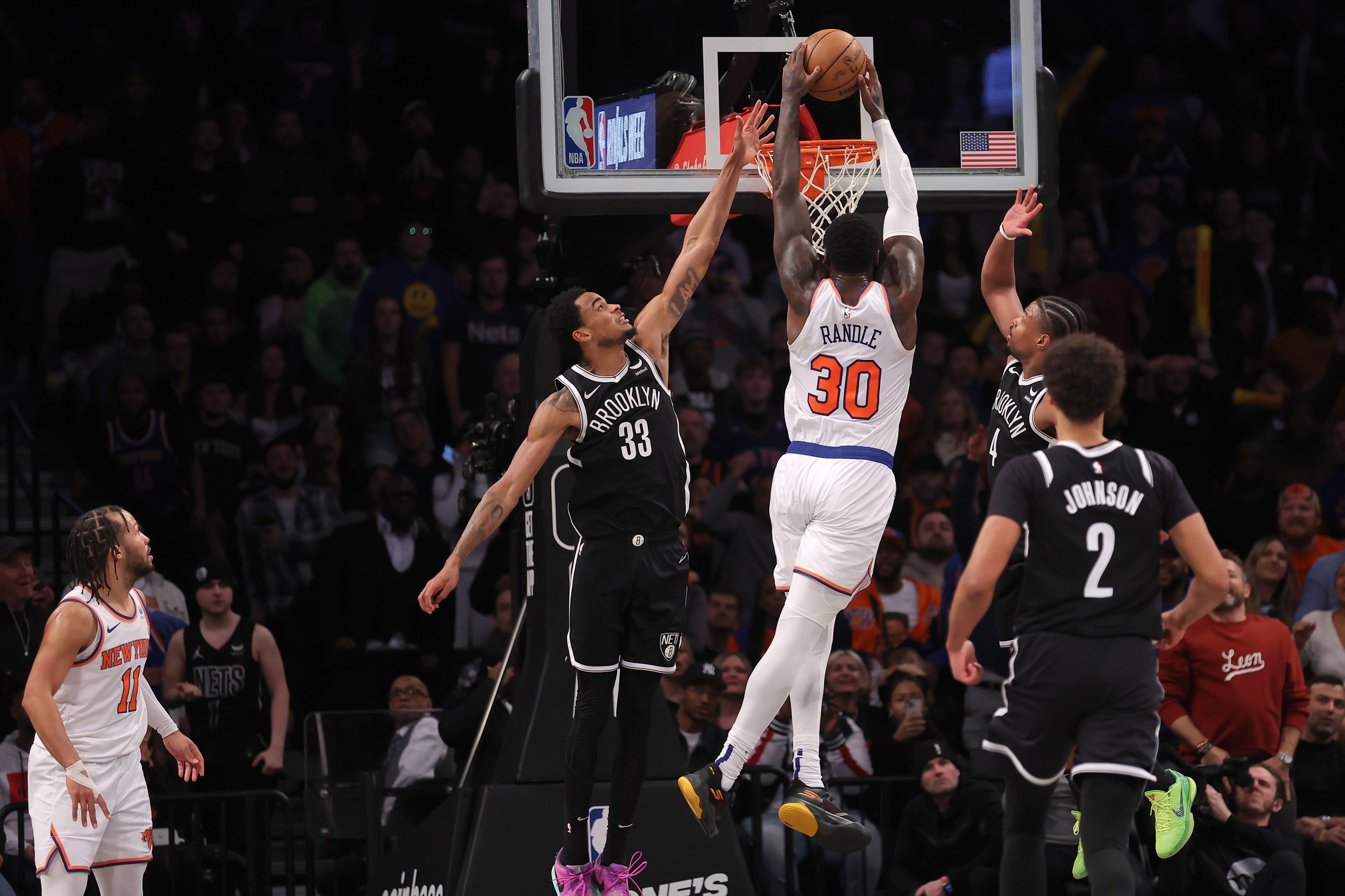 Jan 23, 2024; Brooklyn, New York, USA; New York Knicks forward Julius Randle (30) dunks against Brooklyn Nets center Nic Claxton (33) and guard Dennis Smith Jr. (4) and forward Cameron Johnson (2) in front of Knicks guard Jalen Brunson (11) during the fourth quarter at Barclays Center. Mandatory Credit: Brad Penner-USA TODAY Sports