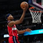 Feb 22, 2024; Denver, Colorado, USA; Washington Wizards guard Bilal Coulibaly (0) finishes off a basket in the second half against the Denver Nuggets at Ball Arena. Mandatory Credit: Ron Chenoy-USA TODAY Sports