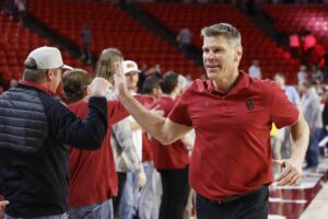 Mar 5, 2024; Norman, Oklahoma, USA; Oklahoma Sooners head coach Porter Moser high fives fans after his team beat the Cincinnati Bearcats in overtime at Lloyd Noble Center. Mandatory Credit: Alonzo Adams-USA TODAY Sports