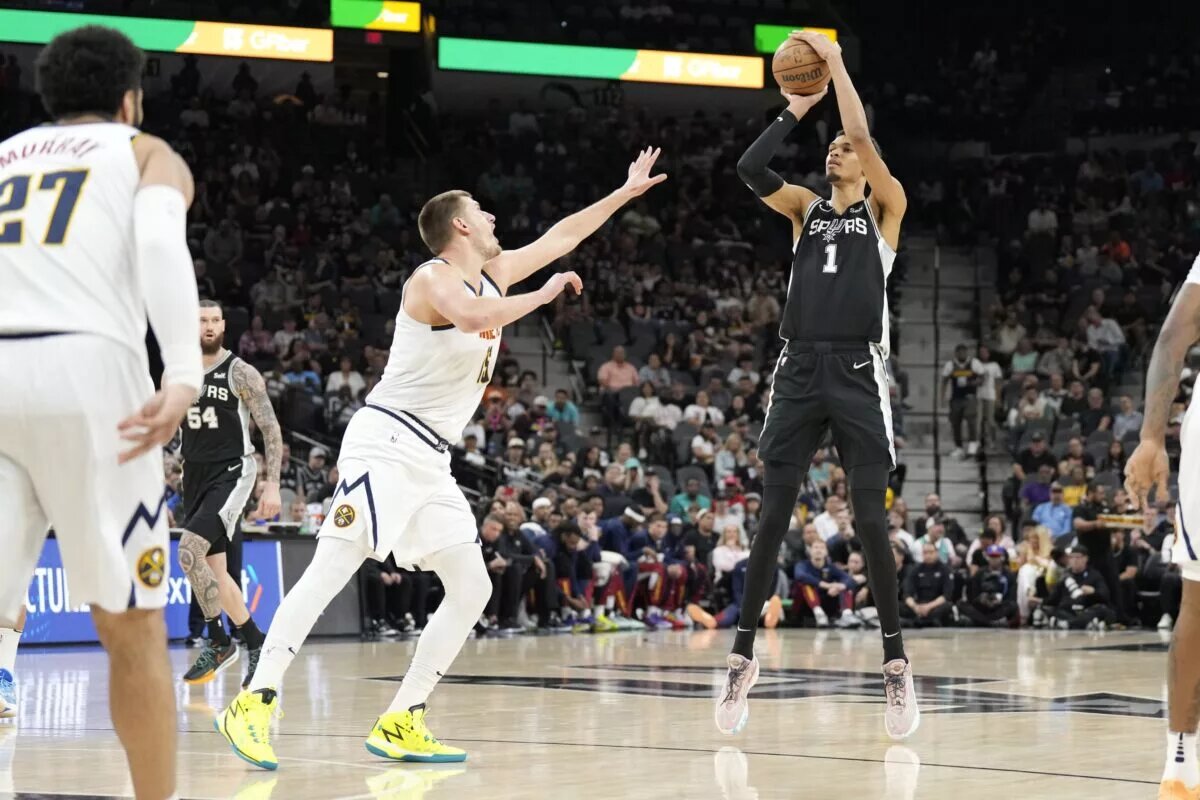 Apr 12, 2024; San Antonio, Texas, USA; San Antonio Spurs forward Victor Wembanyama (1) shoots over Denver Nuggets center Nikola Jokic (15) during the first half at Frost Bank Center. Mandatory Credit: Scott Wachter-USA TODAY Sports