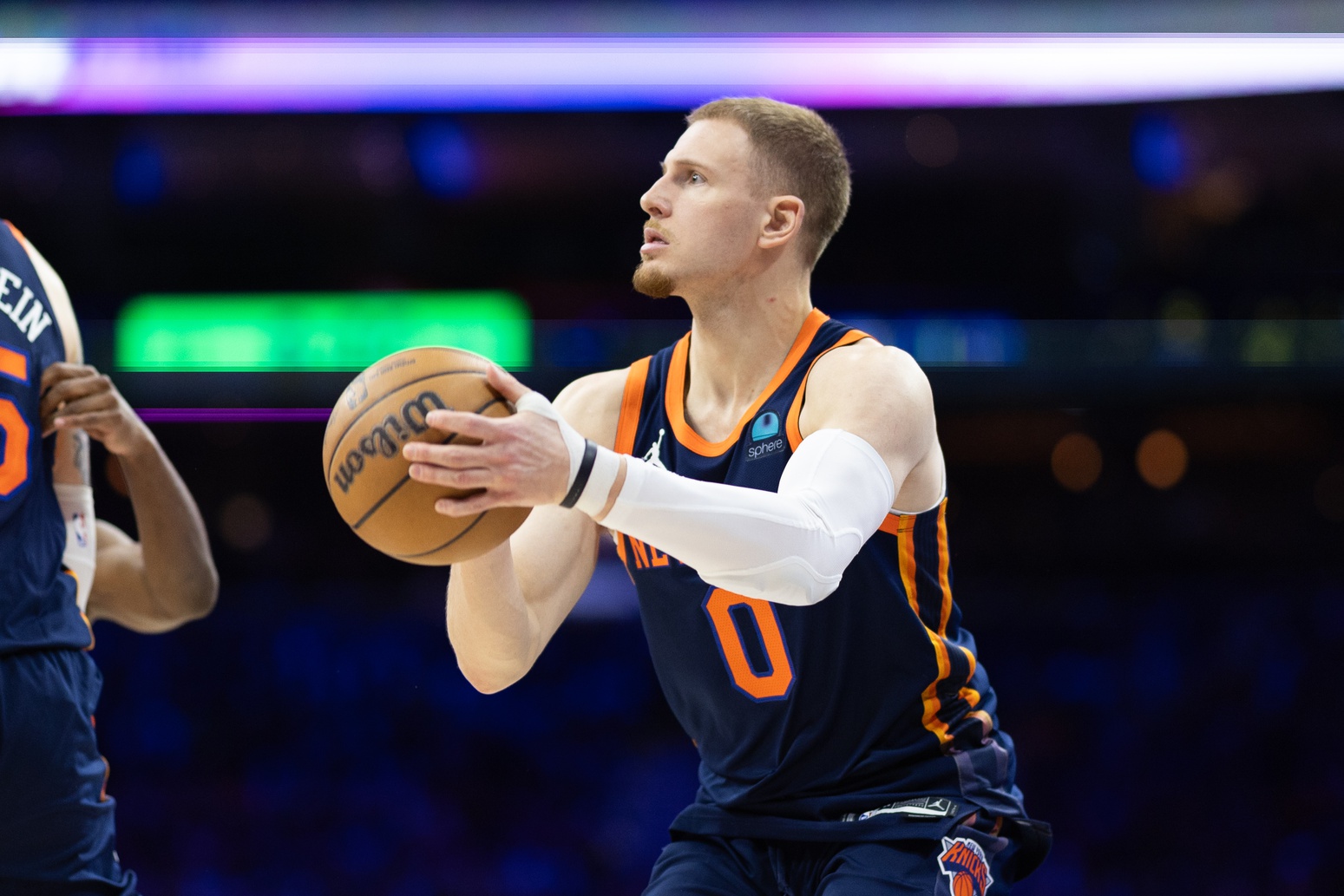 Apr 28, 2024; Philadelphia, Pennsylvania, USA; New York Knicks guard Donte DiVincenzo (0) shoots the ball against the Philadelphia 76ers during the second half of game four of the first round in the 2024 NBA playoffs at Wells Fargo Center. Mandatory Credit: Bill Streicher-USA TODAY Sports