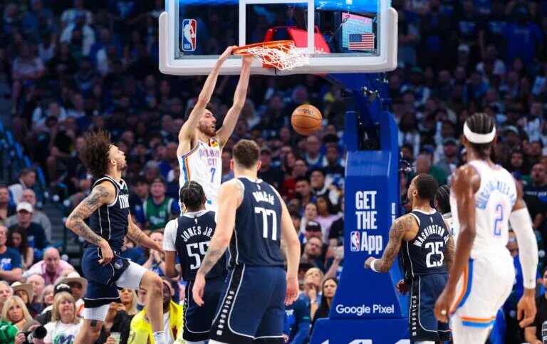 May 11, 2024; Dallas, Texas, USA; Oklahoma City Thunder forward Chet Holmgren (7) dunks over Dallas Mavericks forward Derrick Jones Jr. (55) during the first half during game three of the second round for the 2024 NBA playoffs at American Airlines Center. Mandatory Credit: Kevin Jairaj-USA TODAY Sports