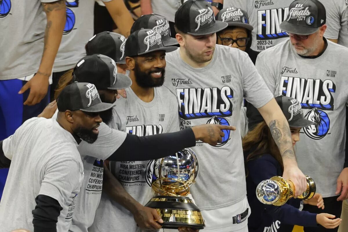 May 30, 2024; Minneapolis, Minnesota, USA; Dallas Mavericks guard Kyrie Irving (11) and guard Luka Doncic (77) celebrate with teammates after winning the Western Conference Championship against the Minnesota Timberwolves in game five of the western conference finals for the 2024 NBA playoffs at Target Center. Mandatory Credit: Bruce Kluckhohn-USA TODAY Sports