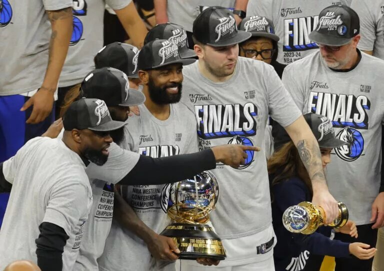May 30, 2024; Minneapolis, Minnesota, USA; Dallas Mavericks guard Kyrie Irving (11) and guard Luka Doncic (77) celebrate with teammates after winning the Western Conference Championship against the Minnesota Timberwolves in game five of the western conference finals for the 2024 NBA playoffs at Target Center. Mandatory Credit: Bruce Kluckhohn-USA TODAY Sports