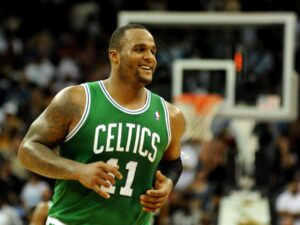 March 19, 2011; New Orleans, LA, USA; Boston Celtics power forward Glen Davis (11) smiles as he runs off court after the Celtics took a lead over the New Orleans Hornets late in the game at the New Orleans Arena. Mandatory Credit: Chuck Cook-USA TODAY Sports
