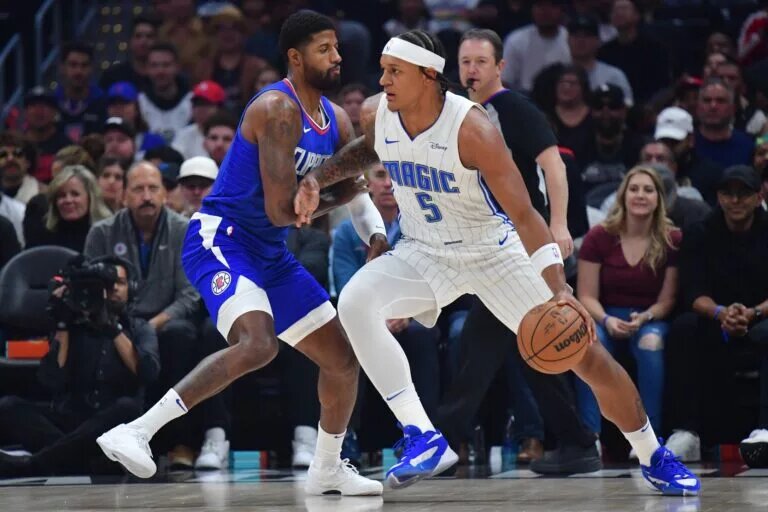 Los Angeles Clippers star Paul George guards Orlando Magic star Paolo Banchero