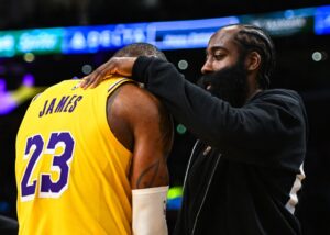 Los Angeles Clippers guard James Harden talks to Los Angeles Lakers forward LeBron James