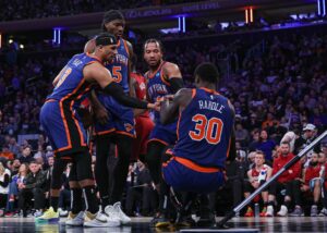 New York Knicks forward Julius Randle helped up by teammates
