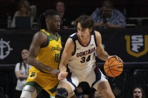 March 11, 2024; Las Vegas, NV, USA; Gonzaga Bulldogs forward Braden Huff (34) dribbles the basketball against San Francisco Dons forward Jonathan Mogbo (10) during the first half in the semifinals of the WCC Basketball Championship at Orleans Arena. Mandatory Credit: Kyle Terada-USA TODAY Sports
