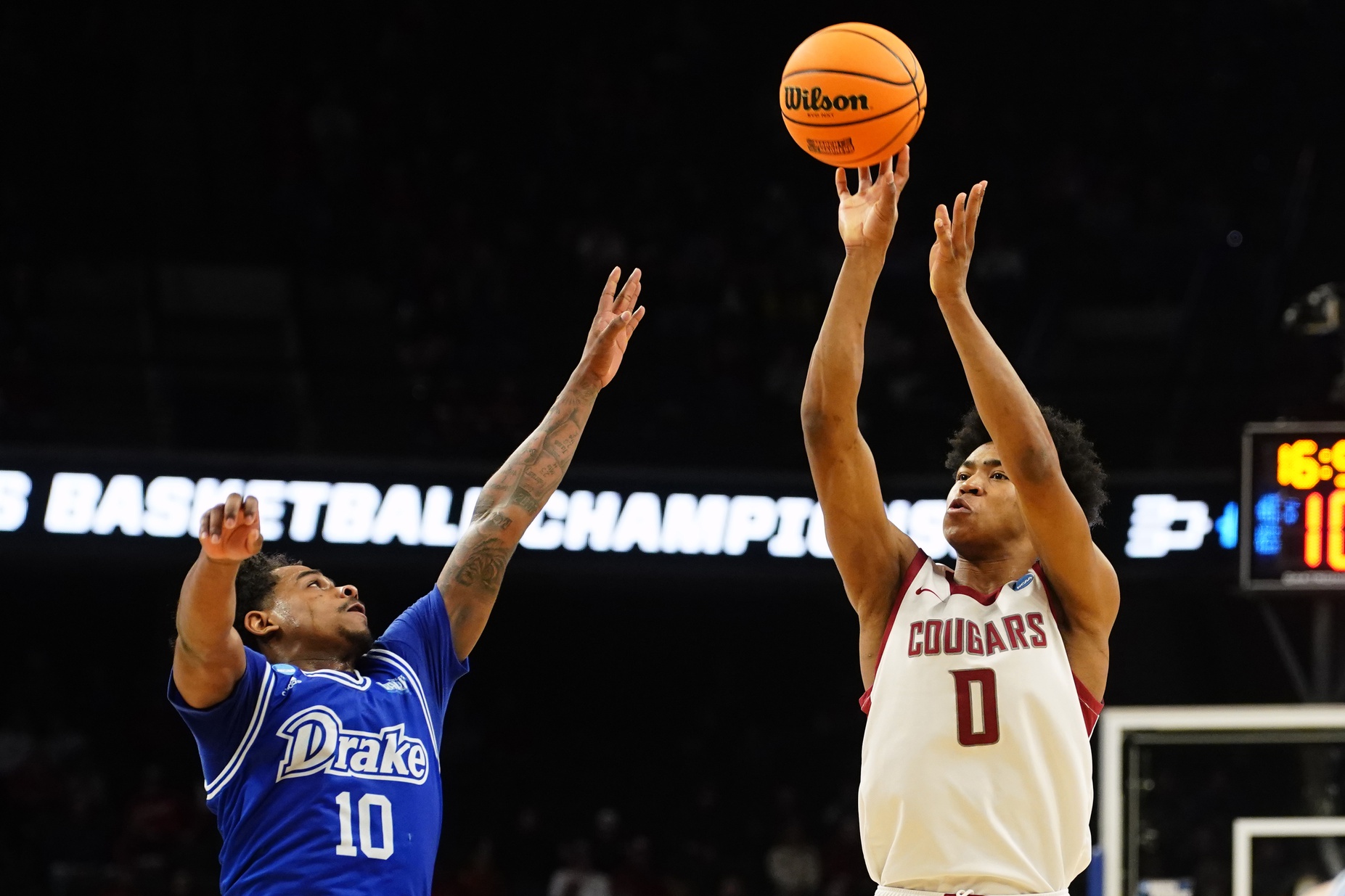 Mar 21, 2024; Omaha, NE, USA; Washington State Cougars forward Jaylen Wells (0) shoots against Drake Bulldogs guard Atin Wright (10) in the second half in the first round of the 2024 NCAA Tournament at CHI Health Center Omaha. Mandatory Credit: Dylan Widger-USA TODAY Sports