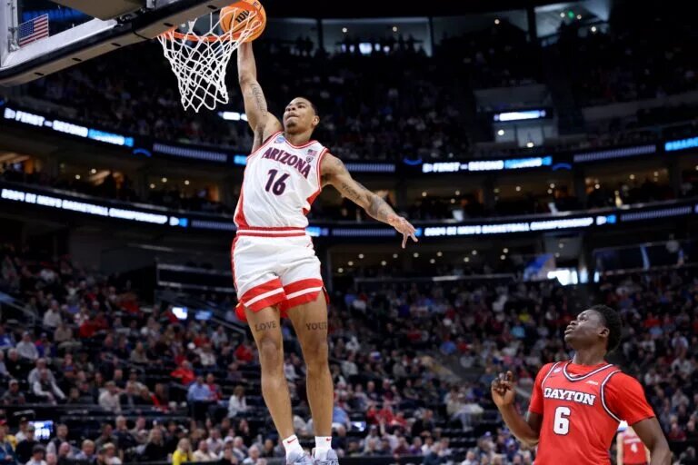 Mar 23, 2024; Salt Lake City, UT, USA; Arizona Wildcats forward Keshad Johnson (16) dunks against Dayton Flyers guard Enoch Cheeks (6) during the first half in the second round of the 2024 NCAA Tournament at Vivint Smart Home Arena-Delta Center. Mandatory Credit: Rob Gray-USA TODAY Sports