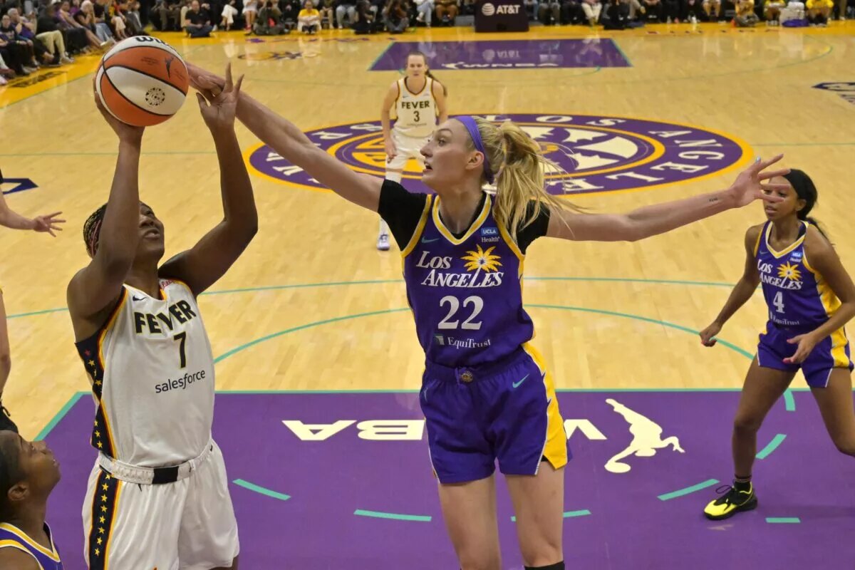 May 24, 2024; Los Angeles, California, USA; Los Angeles Sparks forward Cameron Brink (22) blocks a shot by Indiana Fever forward Aliyah Boston (7) in the first half at Crypto.com Arena. Mandatory Credit: Jayne Kamin-Oncea-USA TODAY Sports