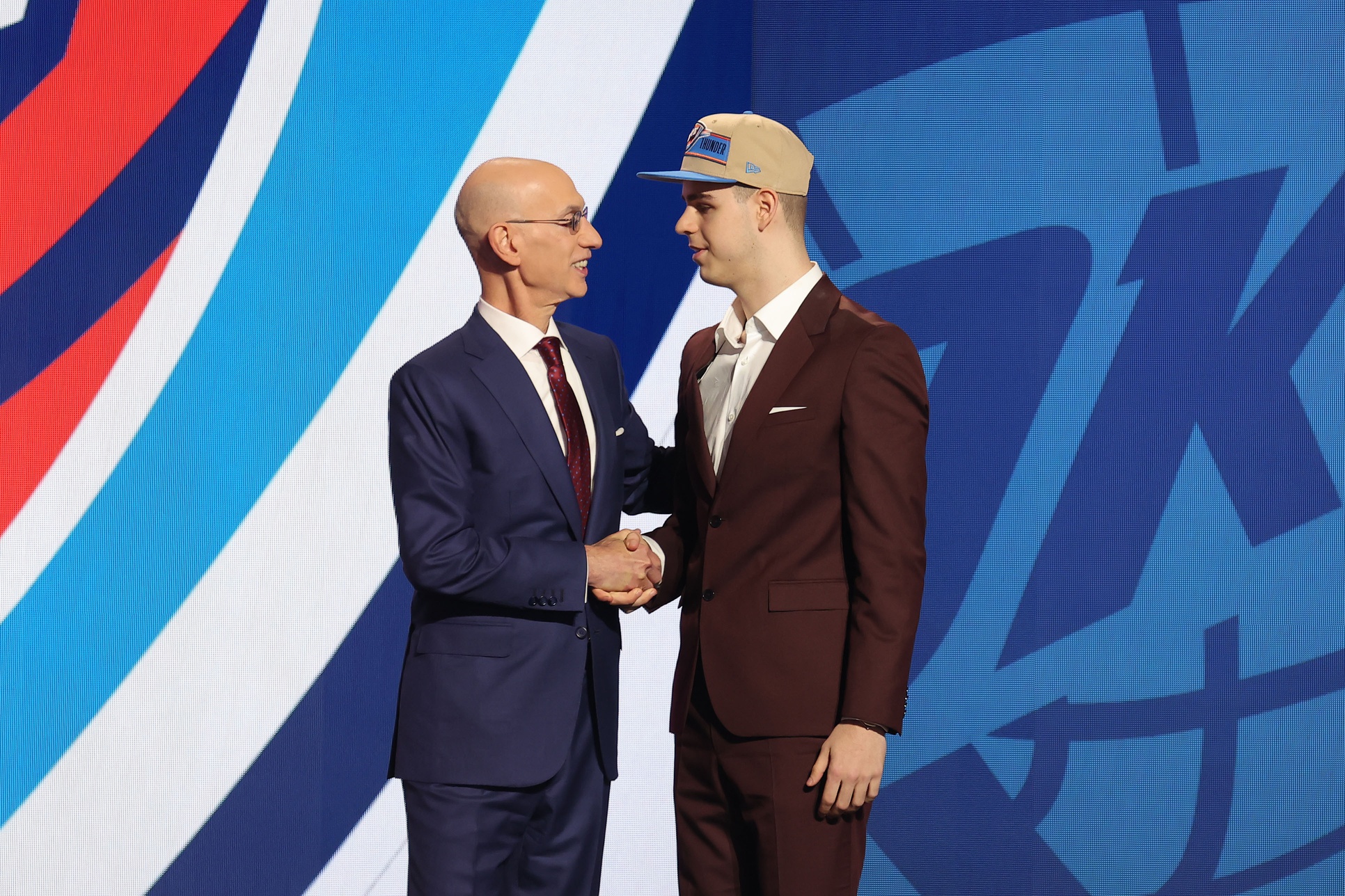 Jun 26, 2024; Brooklyn, NY, USA; Nikola Topic shakes hands with NBA commissioner Adam Silver after being selected in the first round by the Oklahoma City Thunder in the 2024 NBA Draft at Barclays Center. Mandatory Credit: Brad Penner-USA TODAY Sports