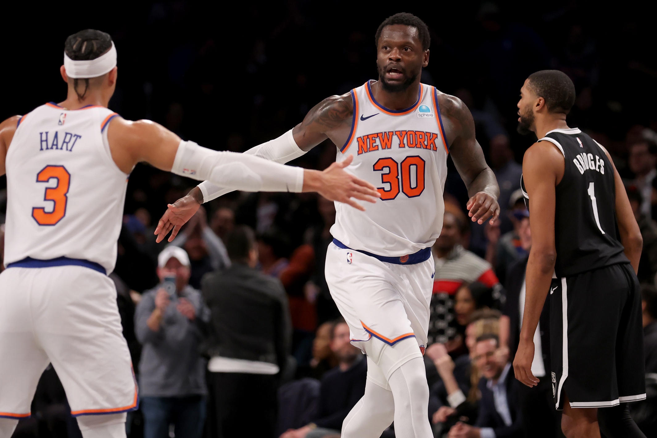 New York Knicks forward Julius Randle (30) daps up guard Josh Hart (3) in front of Brooklyn Nets forward Mikal Bridges (1)