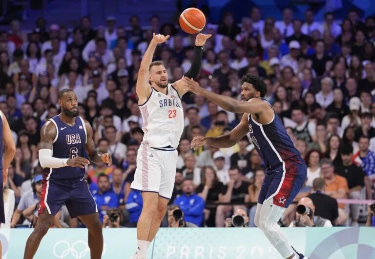 Team USA center Joel Embiid guards Serbia guard Marko Guduric during Paris Olympics