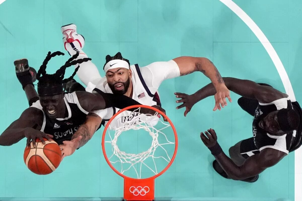 Paris Olympics: Team USA starting center Anthony Davis tries to corral a rebound against South Sudan