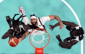 Paris Olympics: Team USA starting center Anthony Davis tries to corral a rebound against South Sudan