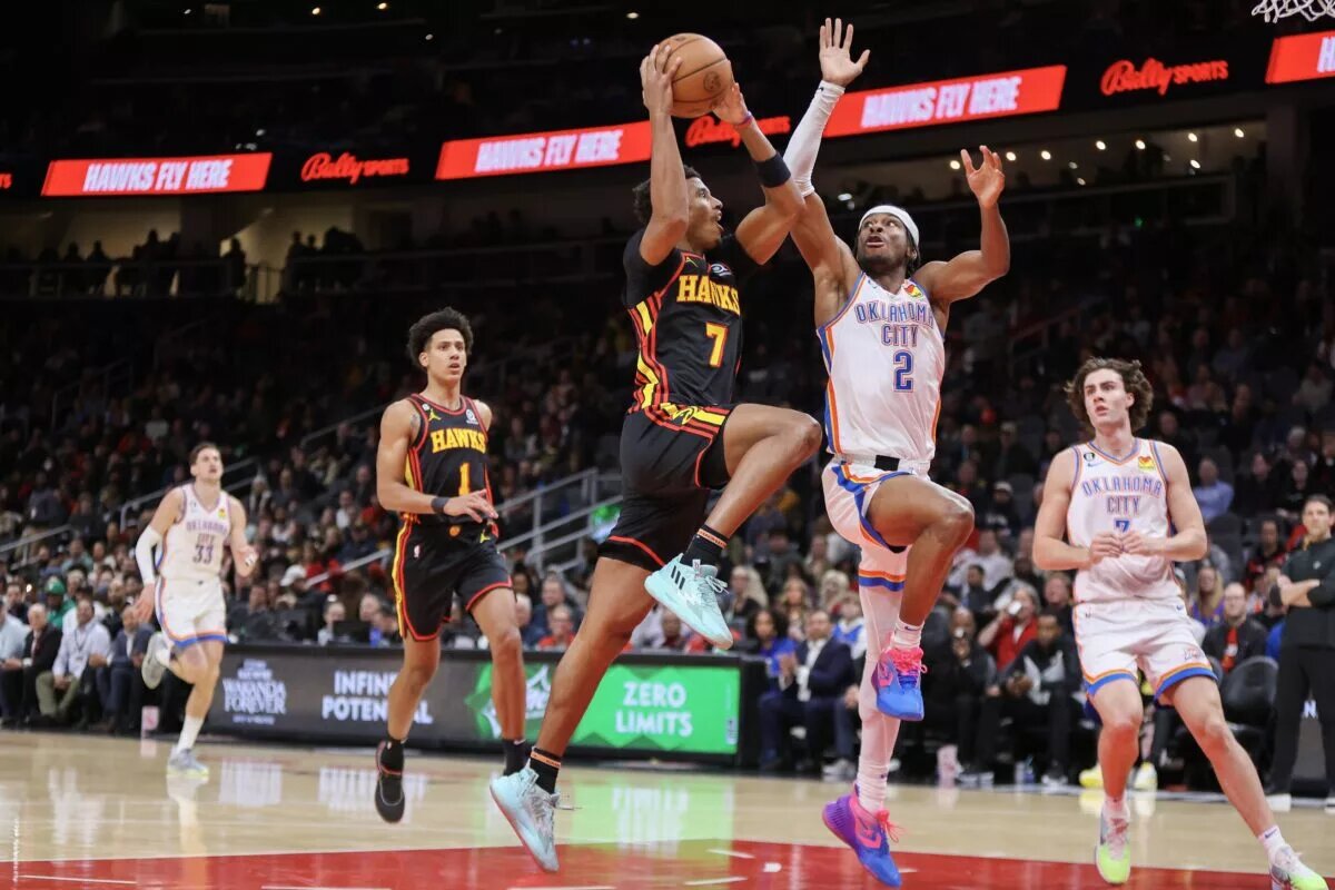 Dec 5, 2022; Atlanta, Georgia, USA; Atlanta Hawks guard Jarrett Culver (7) shoots past Oklahoma City Thunder guard Shai Gilgeous-Alexander (2) in the second quarter at State Farm Arena. Mandatory Credit: Brett Davis-USA TODAY Sports