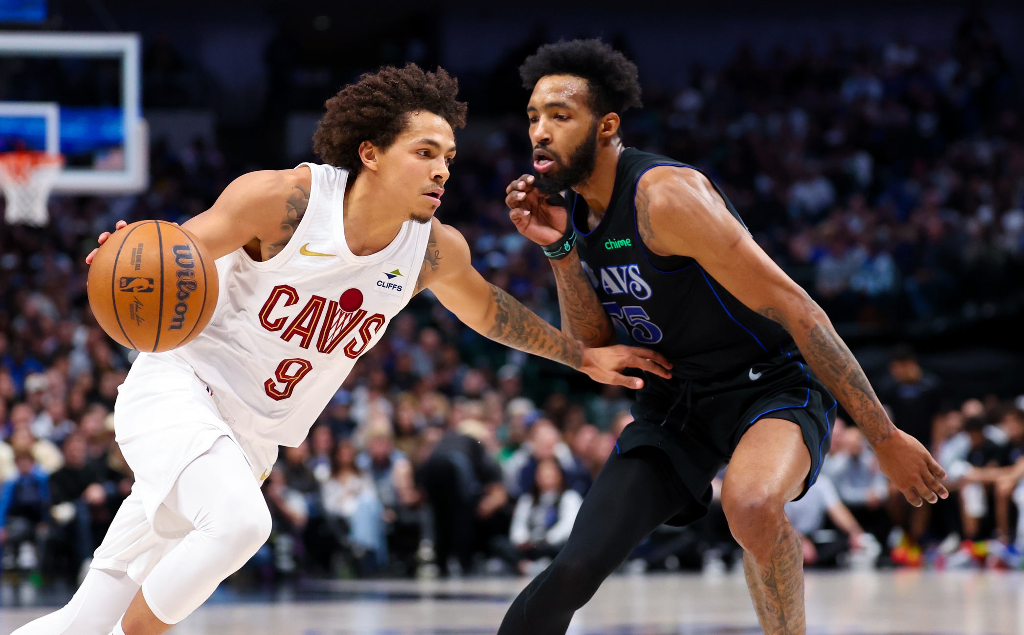 Dec 27, 2023; Dallas, Texas, USA; Cleveland Cavaliers guard Craig Porter (9) drives to the basket as Dallas Mavericks forward Derrick Jones Jr. (55) defends during the first quarter at American Airlines Center. Mandatory Credit: Kevin Jairaj-USA TODAY Sports