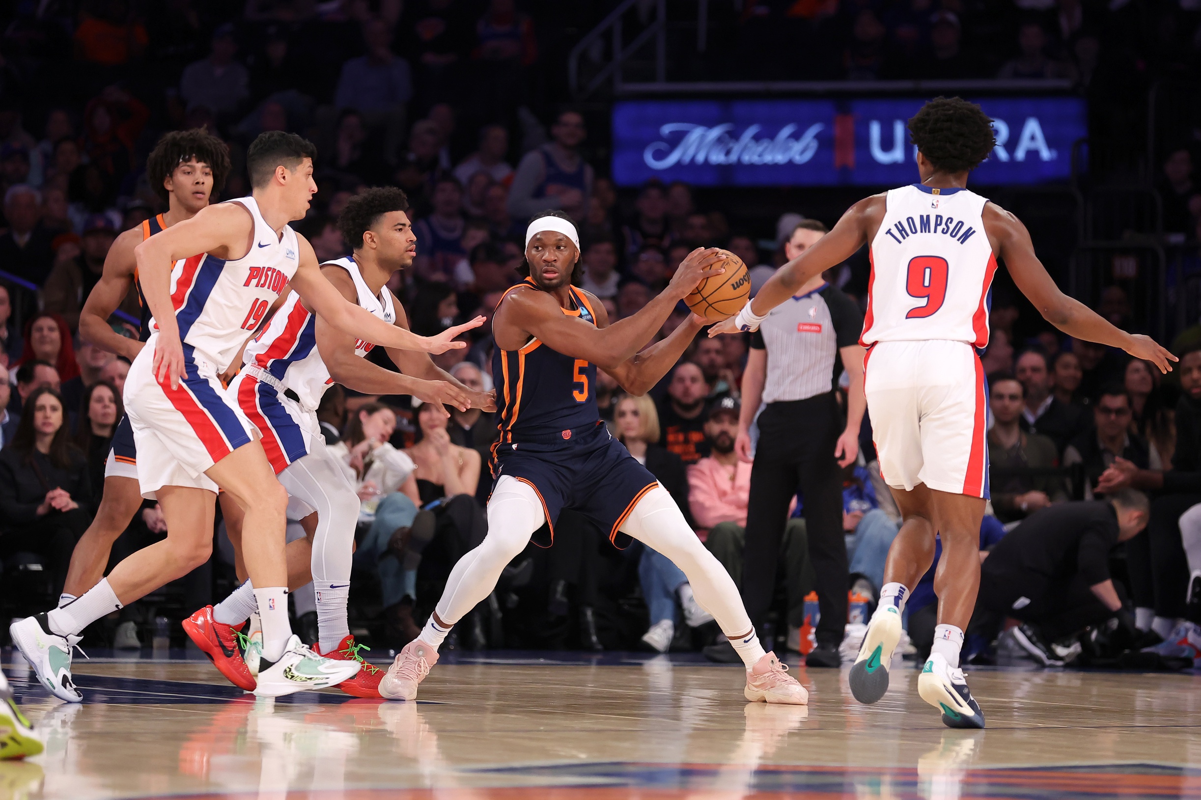 New York Knicks forward Precious Achiuwa (5) controls the ball against Detroit Pistons guard Quentin Grimes (24) and forwards Simone Fontecchio (19) and Ausar Thompson (9) during the first quarter at Madison Square Garden.