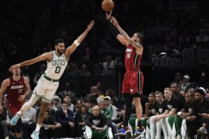 Apr 21, 2024; Boston, Massachusetts, USA; Miami Heat forward Caleb Martin (16) shoots the ball over Boston Celtics forward Jayson Tatum (0) during the second half in game one of the first round for the 2024 NBA playoffs at TD Garden. Mandatory Credit: Bob DeChiara-USA TODAY Sports