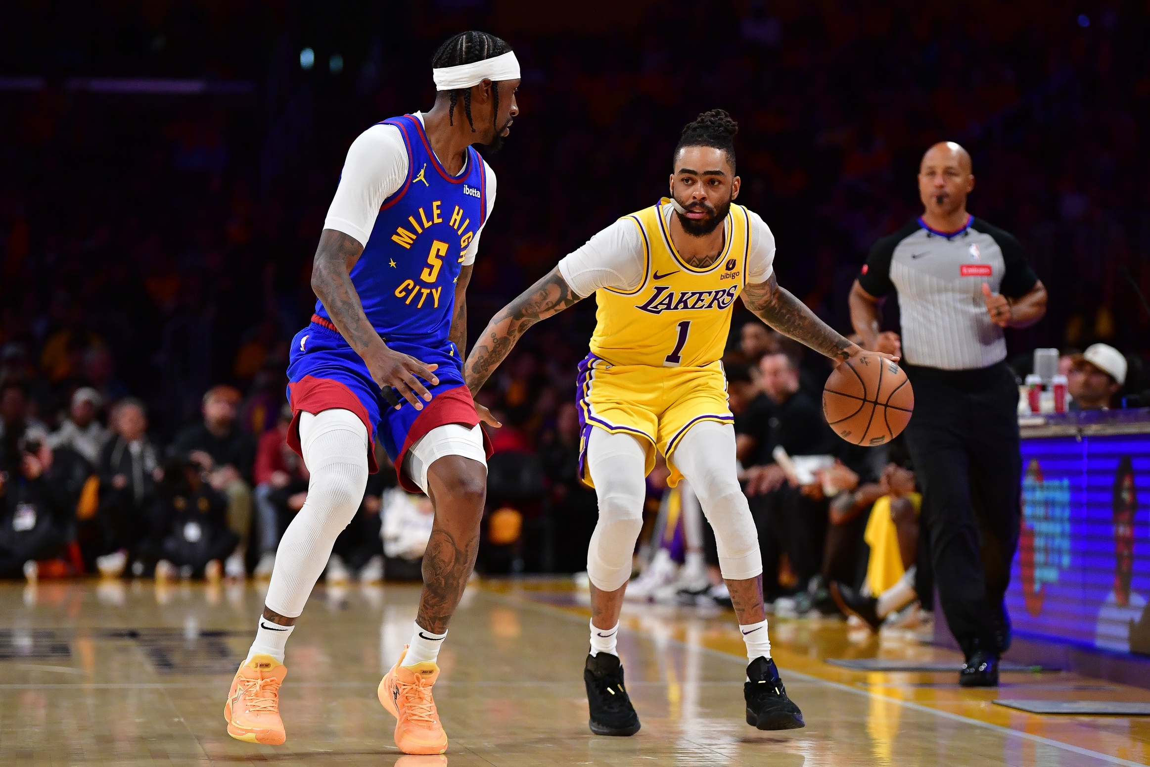 Apr 25, 2024; Los Angeles, California, USA; Los Angeles Lakers guard D'Angelo Russell (1) moves the ball against Denver Nuggets guard Kentavious Caldwell-Pope (5) during the second half in game three of the first round for the 2024 NBA playoffs at Crypto.com Arena. Mandatory Credit: Gary A. Vasquez-USA TODAY Sports