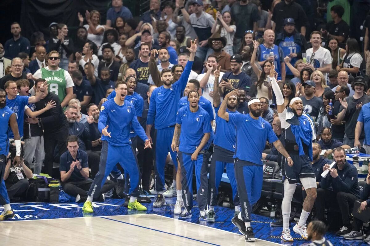 The Dallas Mavericks fans and team bench celebrate during the game between the Dallas Mavericks and the Boston Celtics in game four of the 2024 NBA Finals at American Airlines Center.