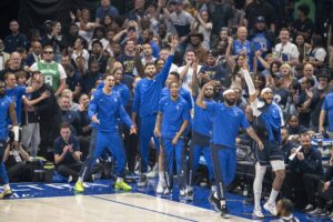 The Dallas Mavericks fans and team bench celebrate during the game between the Dallas Mavericks and the Boston Celtics in game four of the 2024 NBA Finals at American Airlines Center.