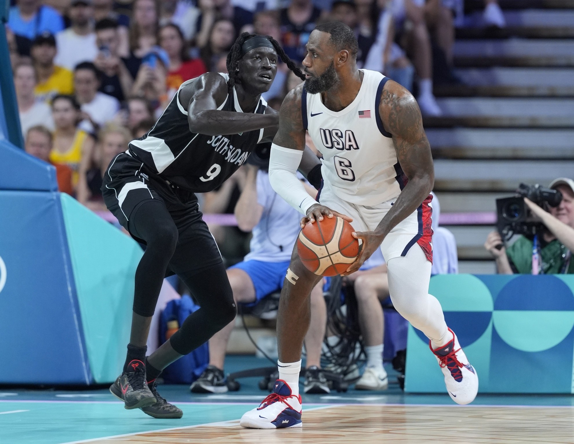 Jul 31, 2024; Villeneuve-d'Ascq, France; United States guard Lebron James (6) dribbles against South Sudan power forward Wenyen Gabriel (9) in the second quarter during the Paris 2024 Olympic Summer Games at Stade Pierre-Mauroy. Mandatory Credit: John David Mercer-USA TODAY Sports