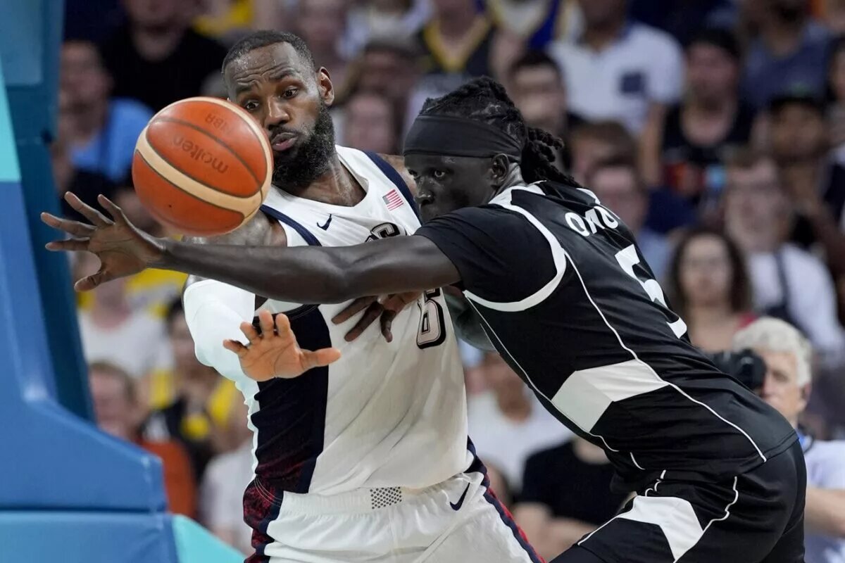 Paris Olympics: South Sudan forward Nuni Omot and Team USA forward LeBron James battle for control of the ball