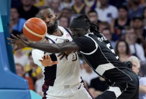 Paris Olympics: South Sudan forward Nuni Omot and Team USA forward LeBron James battle for control of the ball