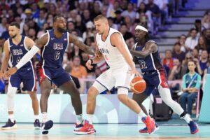 Team USA defenders, including Jrue Holiday, swarm Serbia center Nikola Jokic in the Paris Olympics